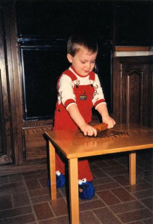 Preschoolers enjoy using child-size utensils to help with baking and other food preparation. (My son at 2½ in 1987)