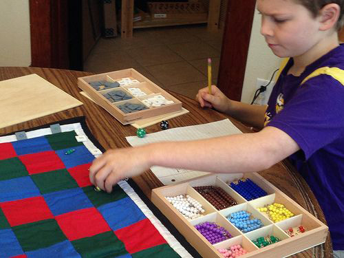 Elementary Math Work with Montessori Checkerboard (Photo from Work and Play, Day by Day