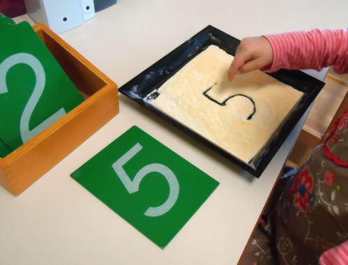 Sandpaper Numerals and Cornmeal Writing Tray (Photo from Dirigo Montessori School)