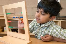 Student Working with the Small Bead Frame (Photo from Montessori Compass)